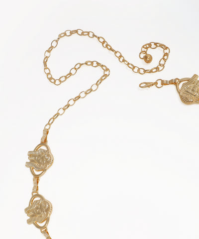 Gold chain necklace with heart-shaped pendants on a white background