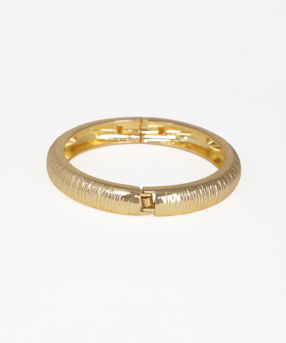 Gold bracelet on a white background