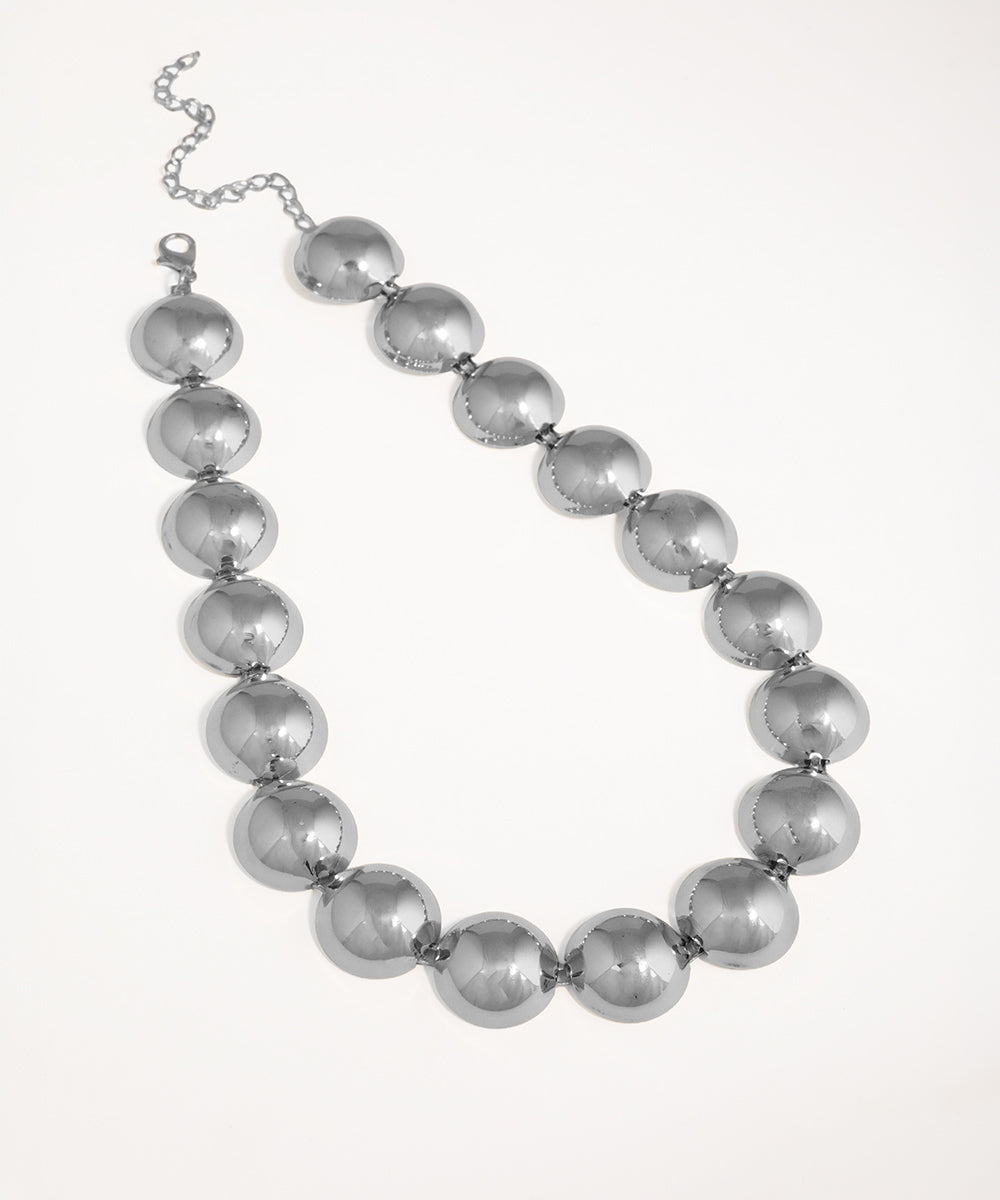 Silver beaded necklace on a white background