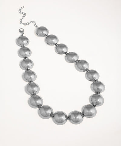 Silver beaded necklace on a white background