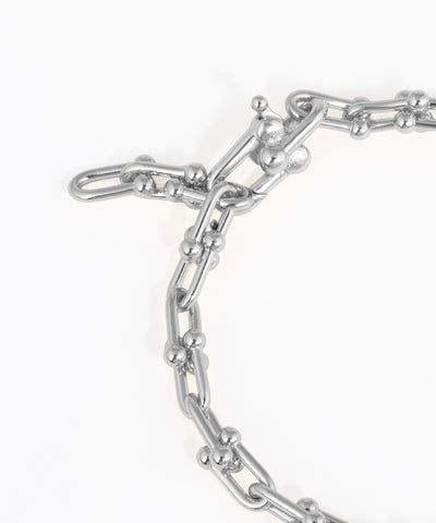 Close-up of a silver chain bracelet on a white background
