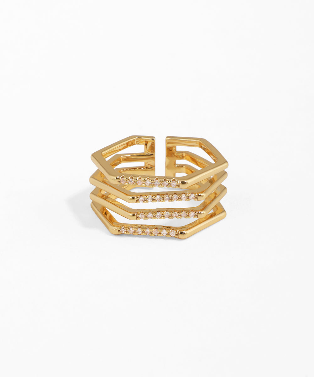 Gold ring with geometric design on a white background