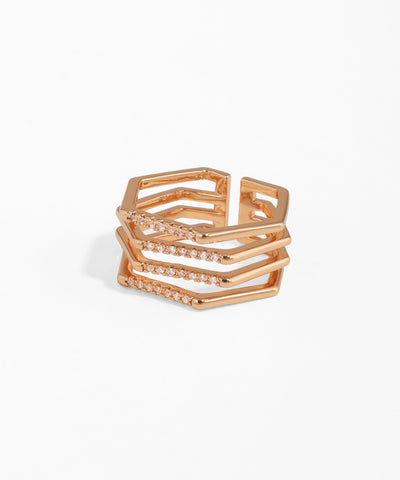 Rose gold ring with geometric design on a white background