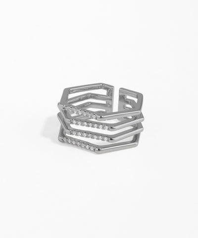Stack of silver rings with geometric design on a white background