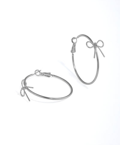 Rhodium finish hoop earrings with a small bow charm