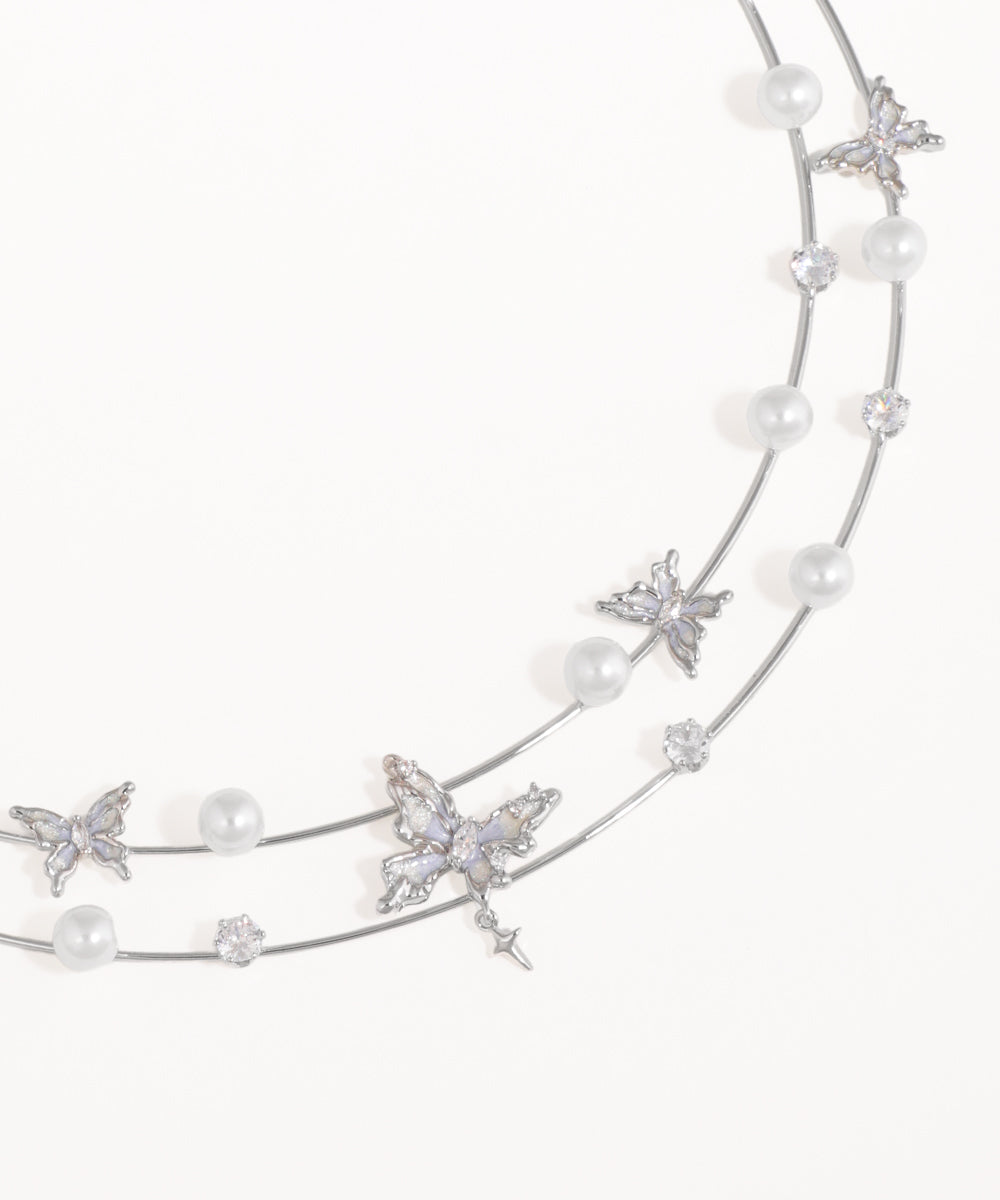 Silver headband with pearls and starfish decorations on a white background
