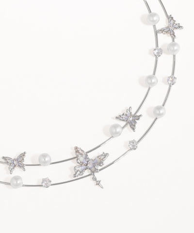 Silver headband with pearls and starfish decorations on a white background