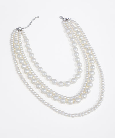 Silver-tone necklace with four cascading strands of faux pearls in varying sizes.