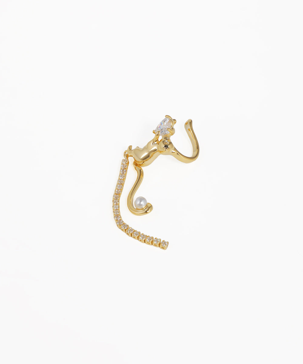 Gold cat-shaped earring on a white background