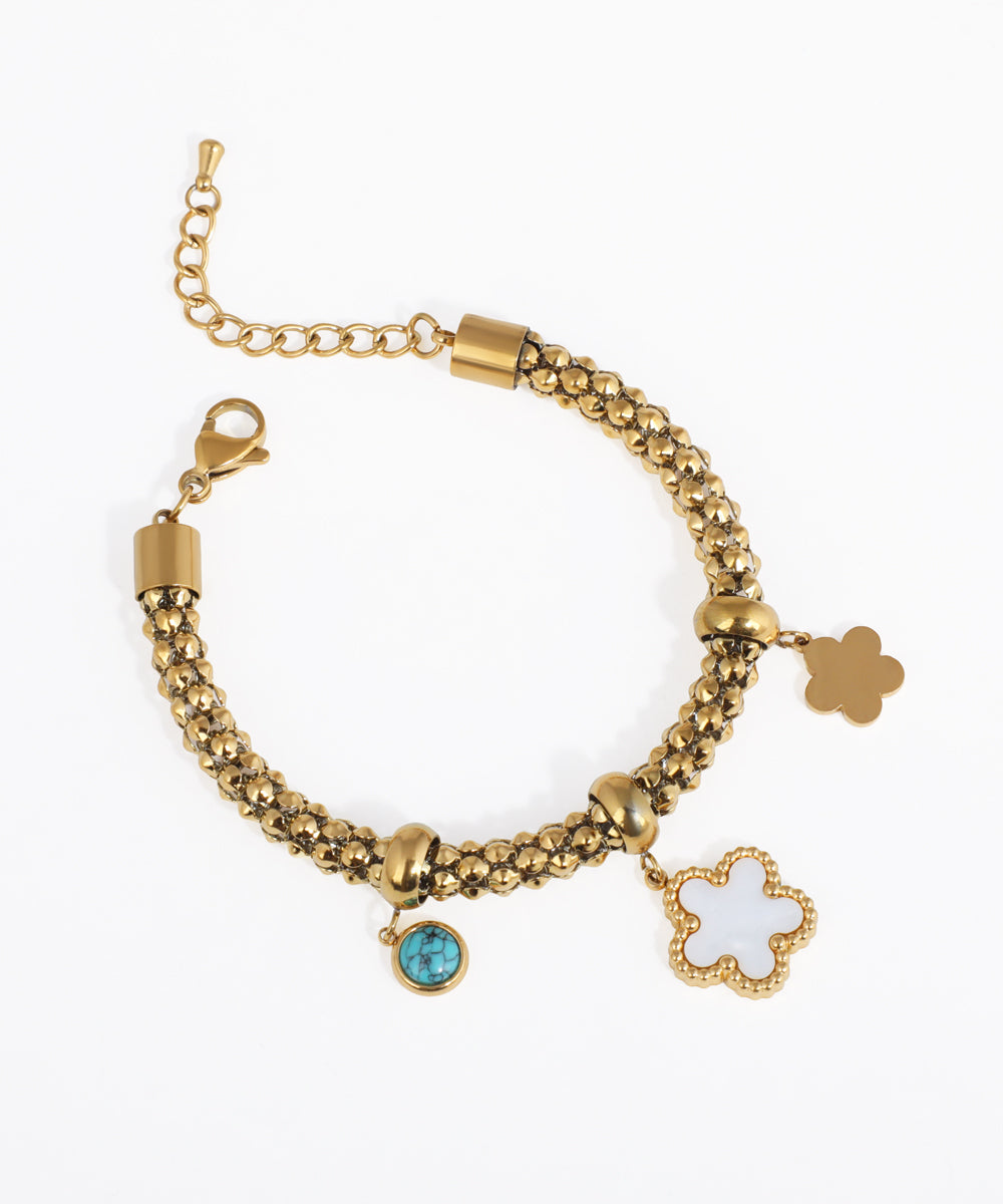 Gold-tone beaded chain bracelet with white clover, gold clover, and faux turquoise charms