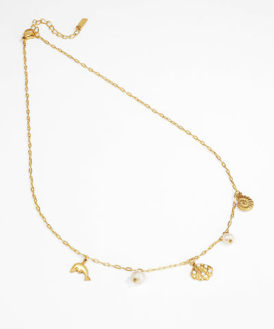 Gold anklet with various charms on a white background