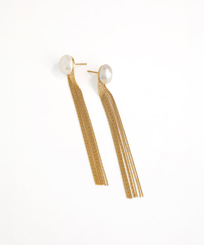 Gold tassel earrings with pearl-like tops on a white background