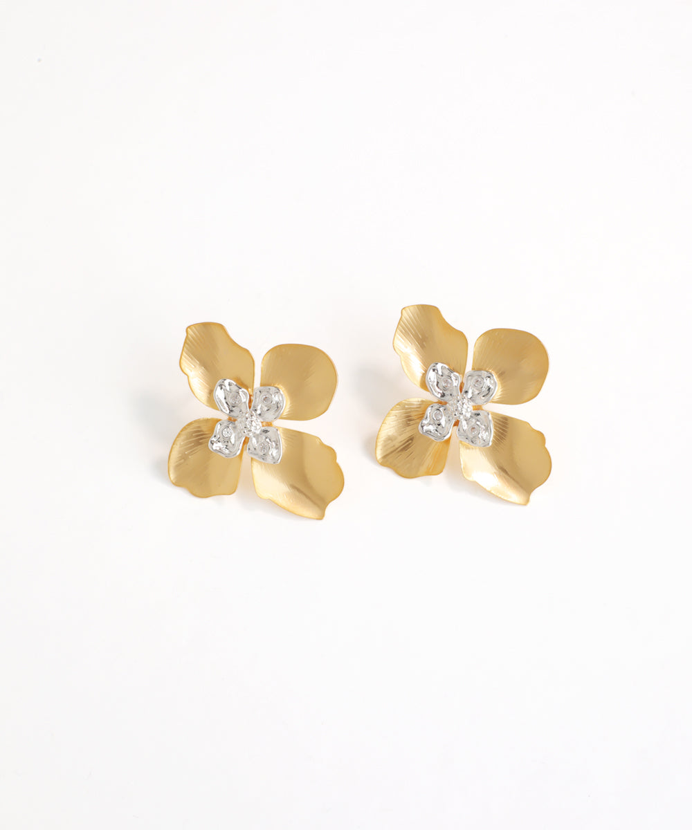 Gold flower-shaped earrings with clear gemstones on a white background