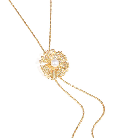 Gold necklace with a floral pendant on a white background