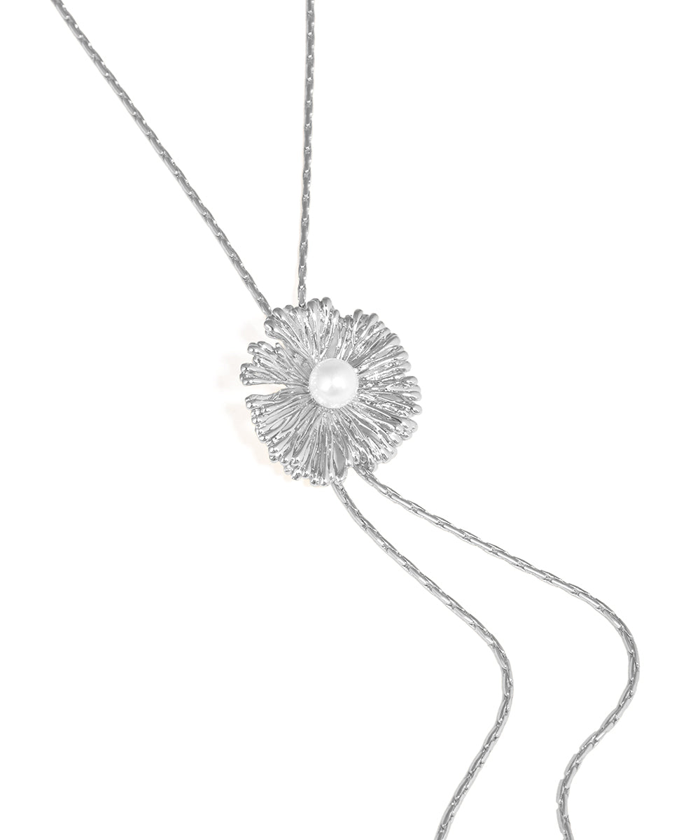 Silver necklace with a floral pendant on a white background