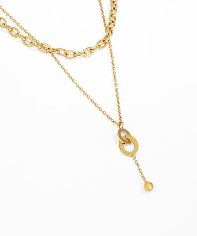 Gold necklace with a small pendant on a white background