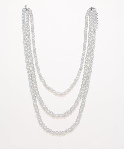 Silver-tone layered necklace with three strands of round faux pearls.