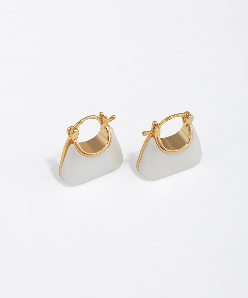 Gold-tone hoop earrings with white enamel mini bag design