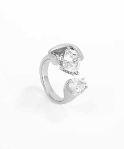 Silver ring with two clear gemstones on a white background