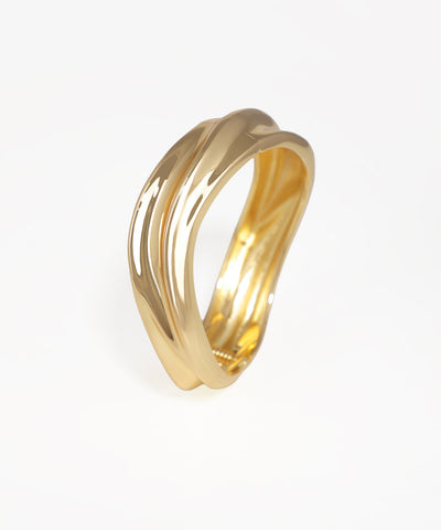 Gold-tone bangle kada with a polished, fluid, and twisted sculptural design