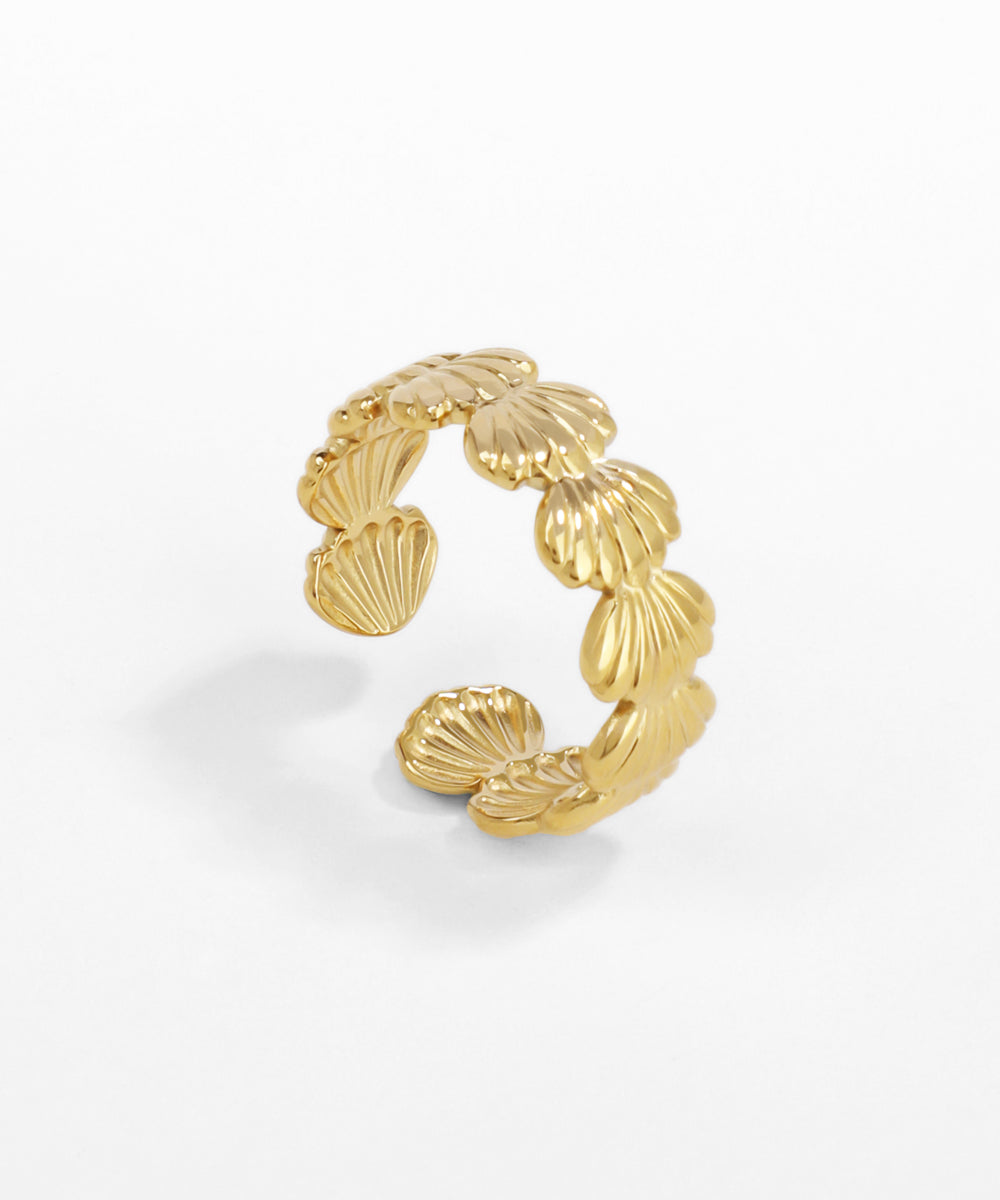 Gold leaf-shaped earring on a white background