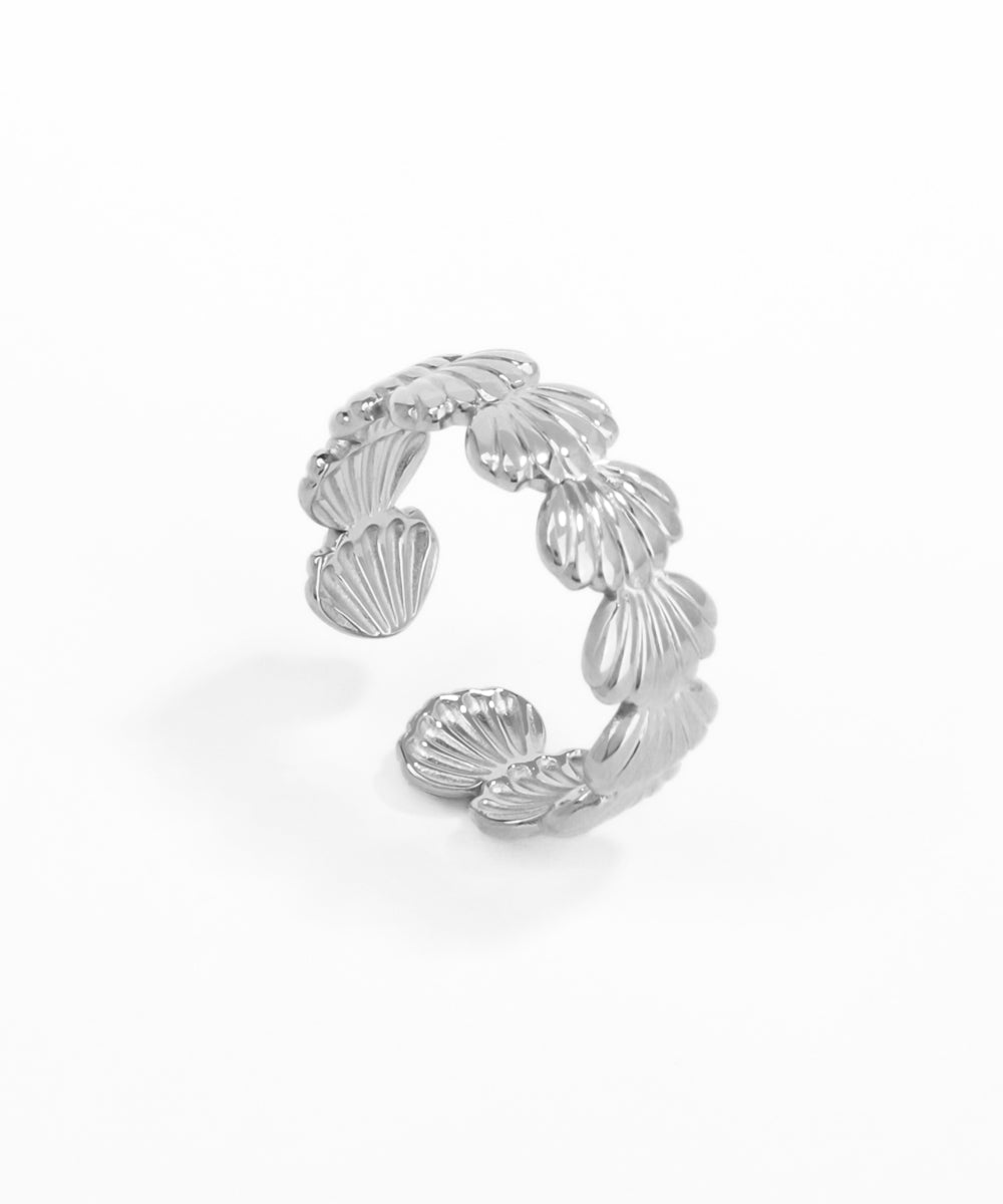 Silver leaf-shaped earring on a white background