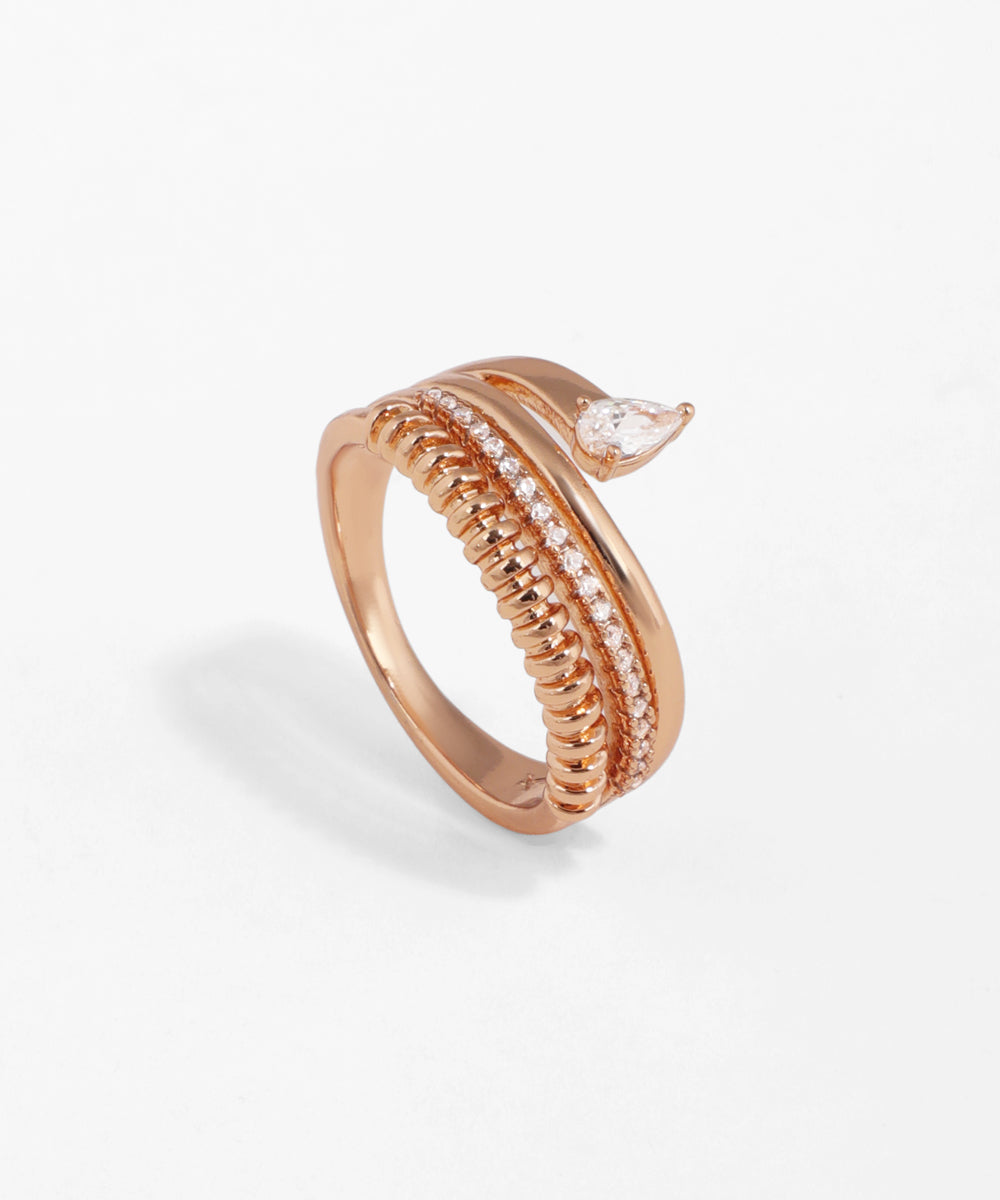 Rose-gold-tone wrap ring with ridged texture, pave-set small stones, and a pear-cut CZ stone