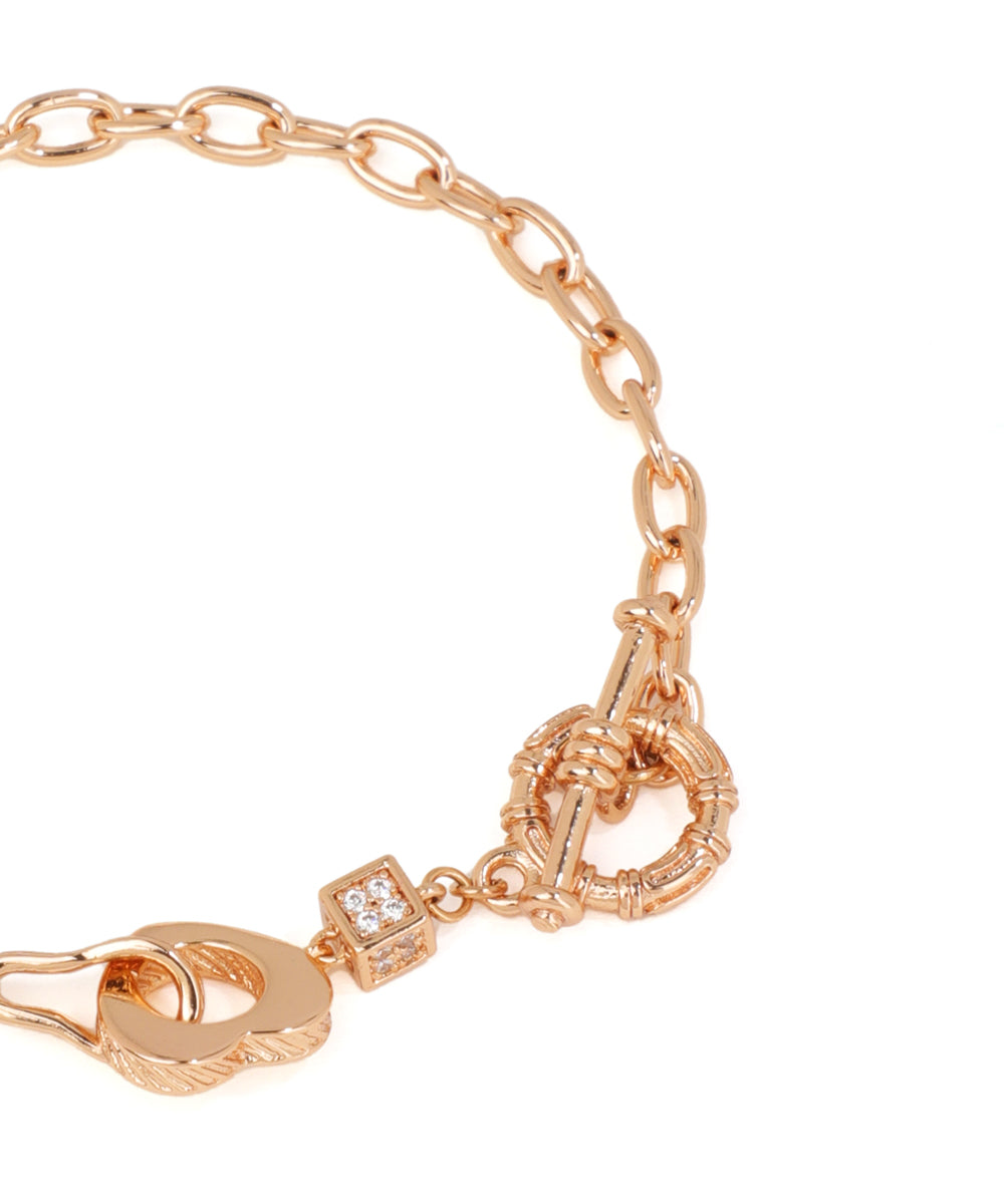 Rose gold bracelet with intricate design on a white background