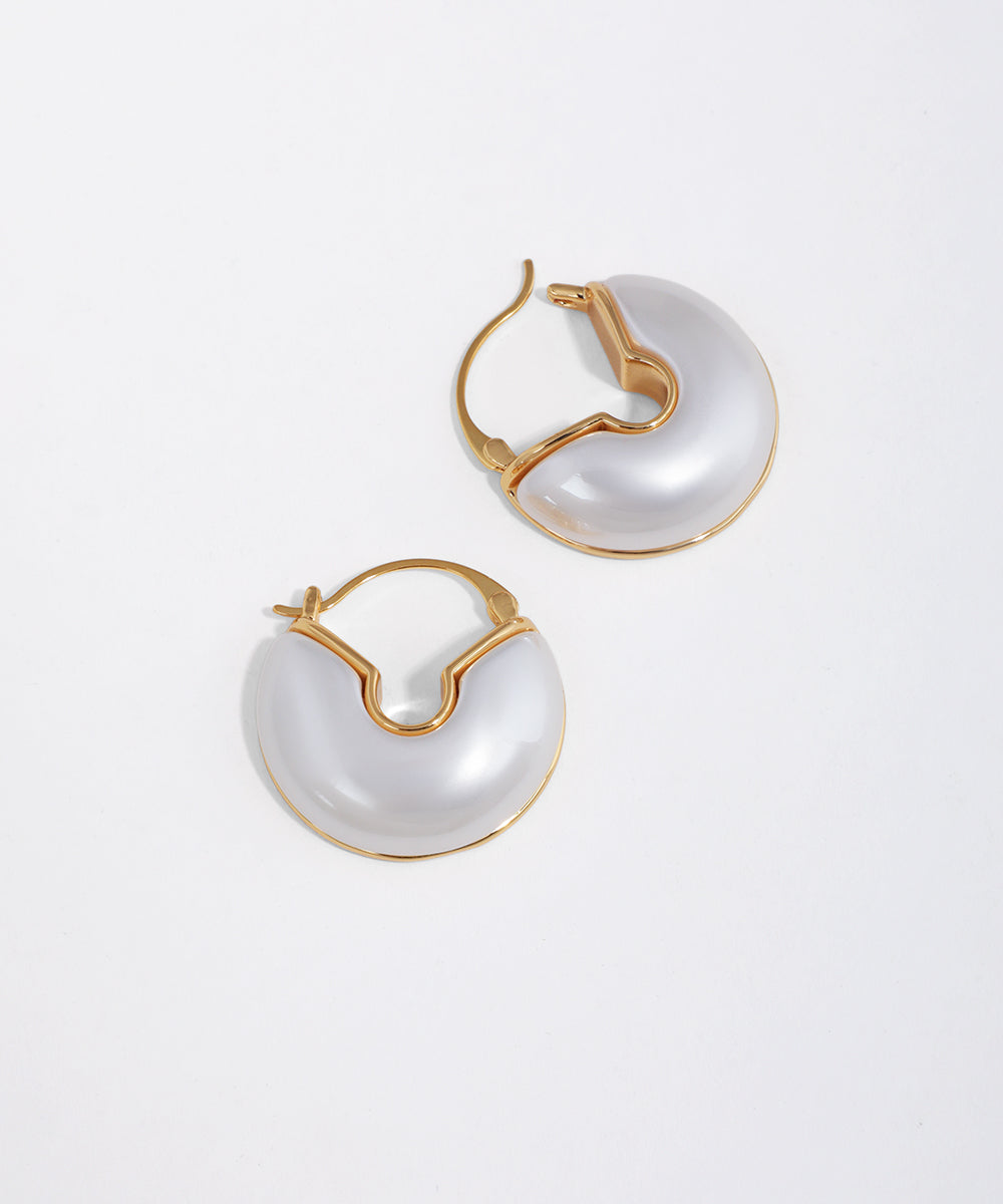 Gold-tone hoop earrings with a smooth white pearl-effect inlay