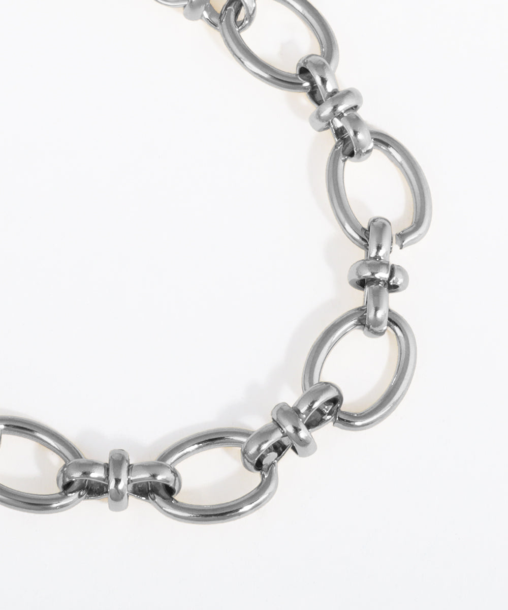Close-up of a silver chain bracelet on a white background