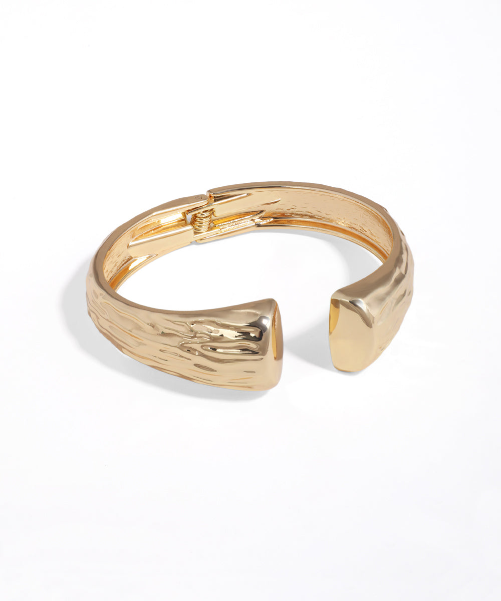 Gold bracelet on a white background