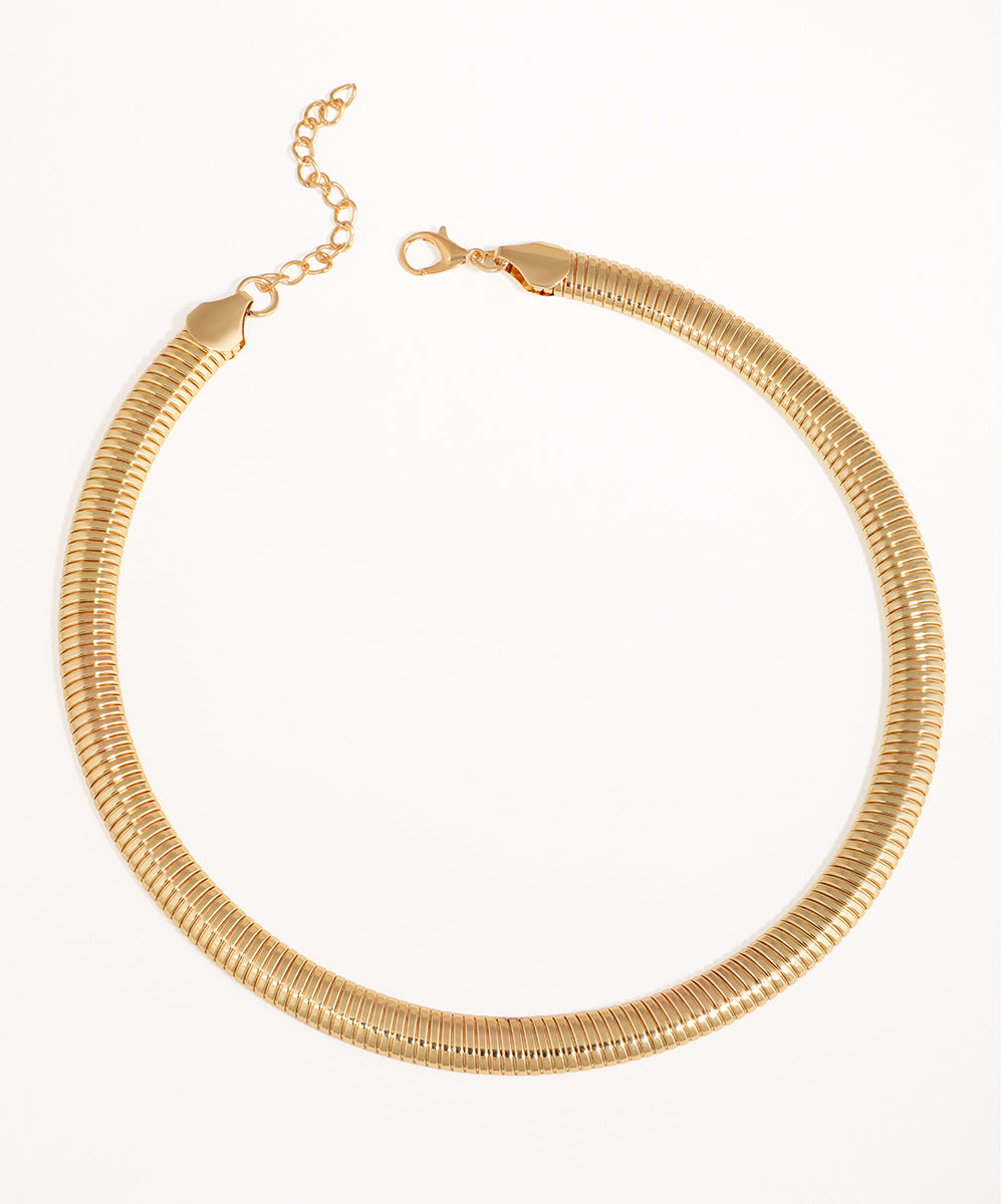 Gold-tone necklace with a wide, flexible snake chain design and lobster clasp closure