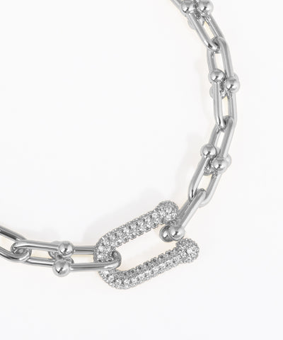 Silver chain bracelet with diamond accents on a white background