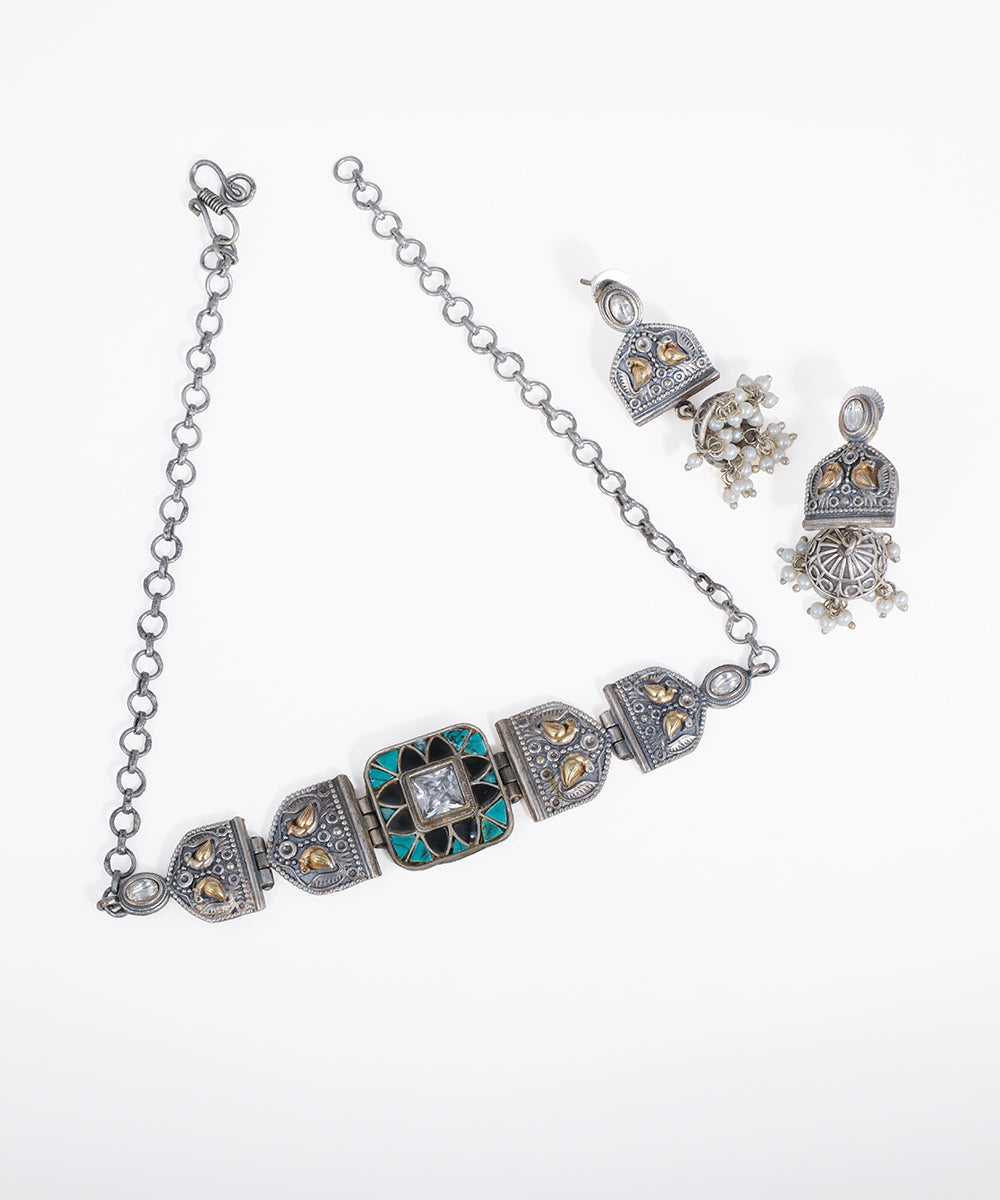 Silver jewelry set with necklace, earrings, and bracelet on a white background