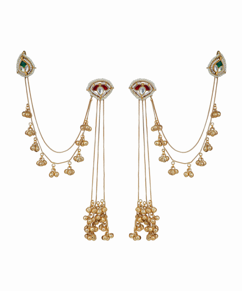 Pair of gold earrings with gemstones on a white background