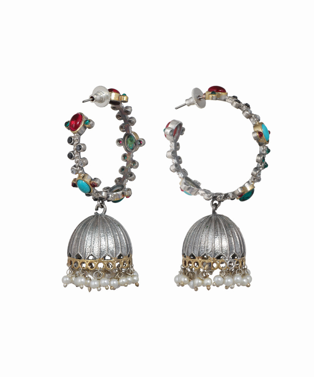 Pair of silver hoop earrings with colorful beads on a white background