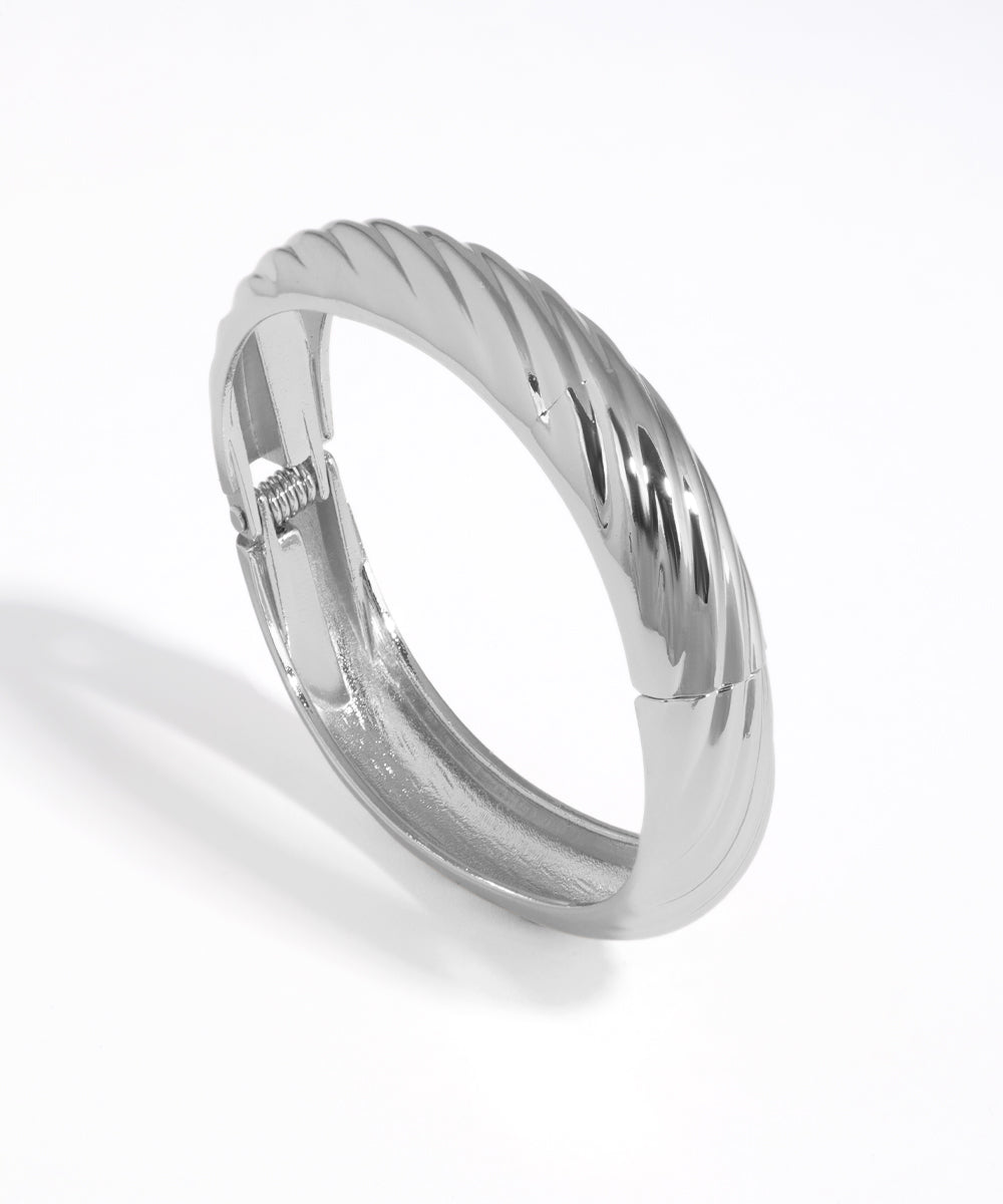 Silver ring with a textured band on a white background