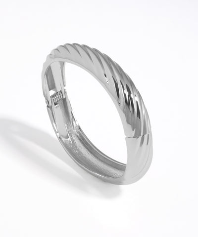 Silver ring with a textured band on a white background