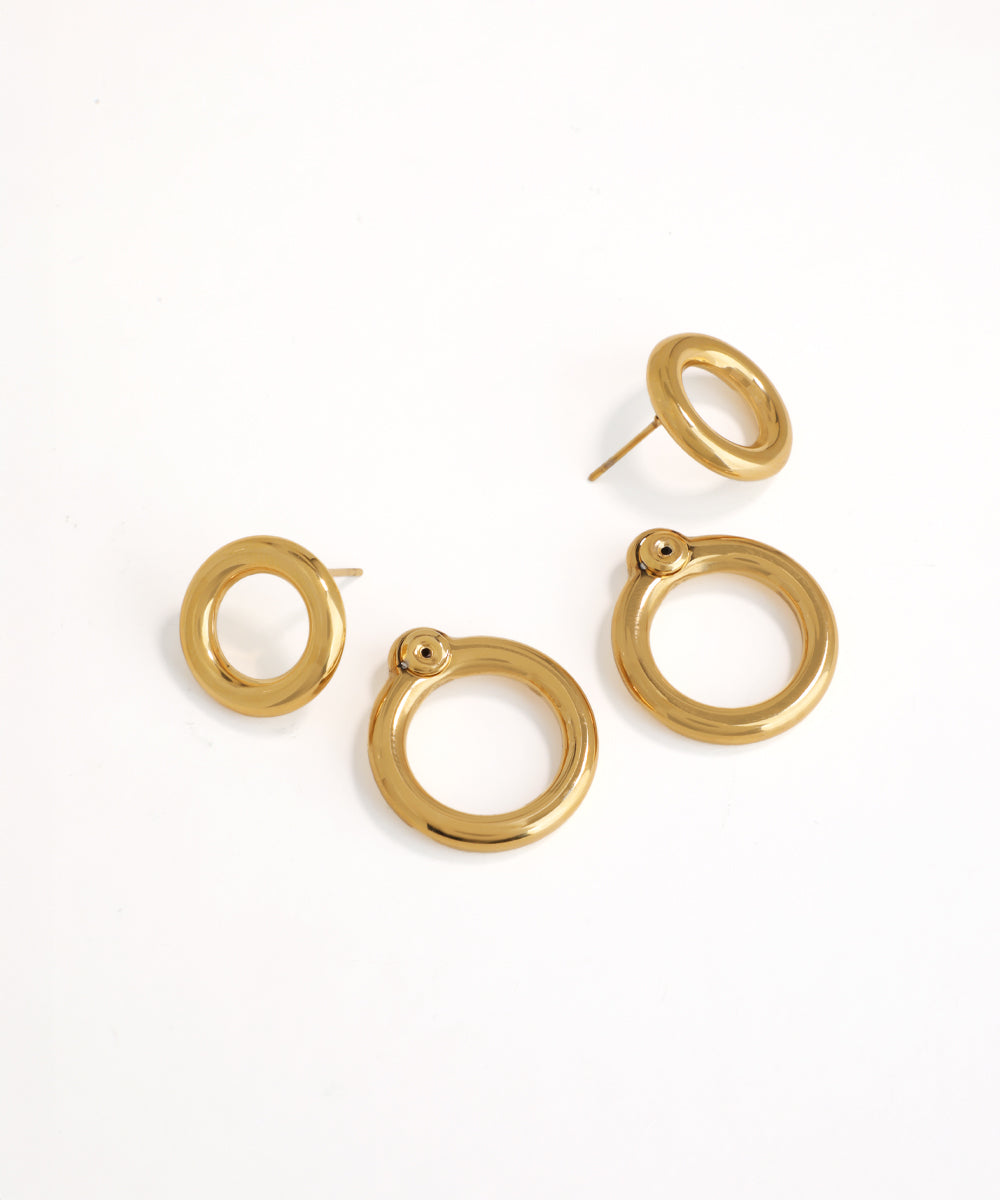 Set of gold hoop earrings on a white background