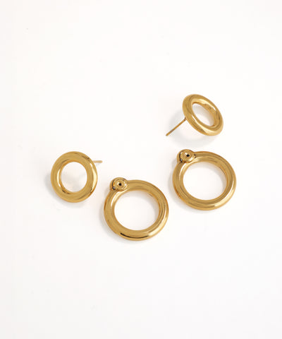 Set of gold hoop earrings on a white background