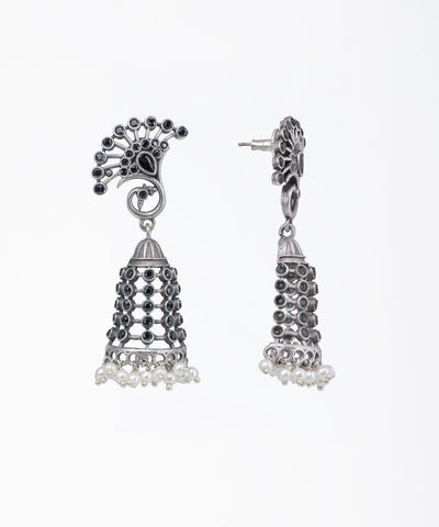 Silver jhumka earrings with black stones on a white background