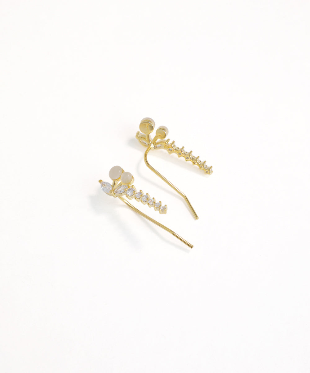 Gold hair pins with decorative elements on a white background