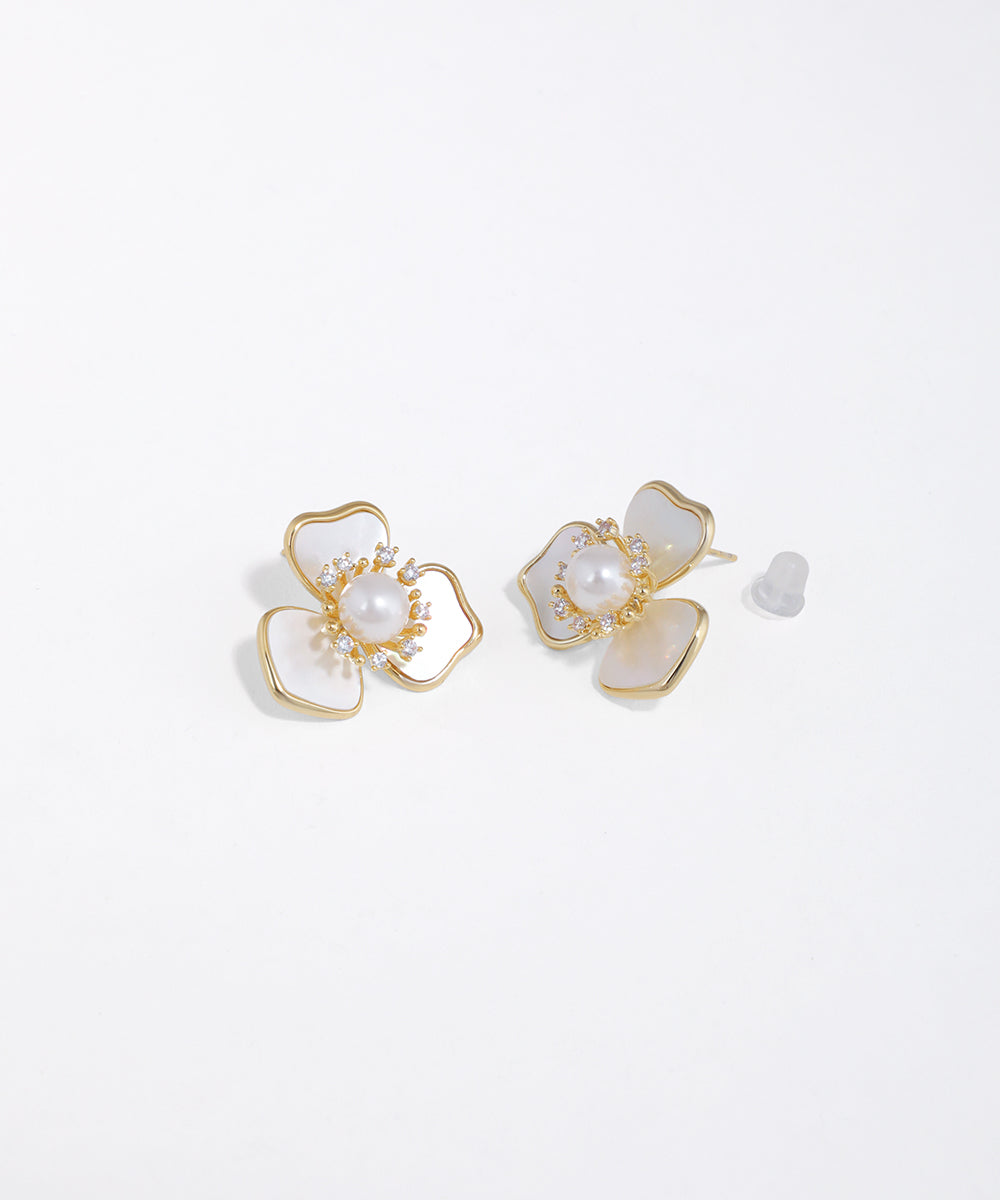 Gold-tone floral stud earrings with iridescent petals, a central faux pearl, and surrounding clear CZ stones.