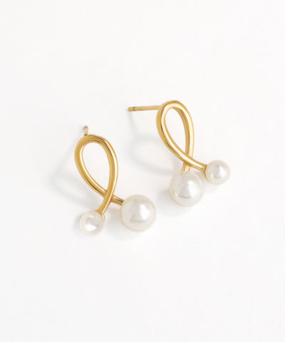 Gold earrings with pearls on a white background