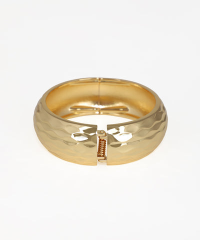 Gold ring with a unique design on a white background