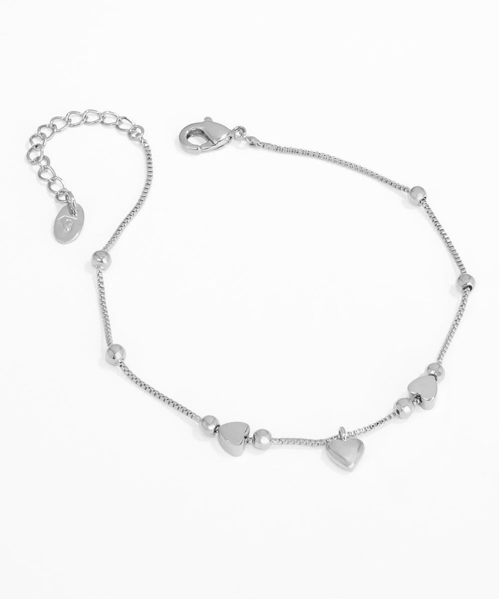 Silver bracelet with heart-shaped charms on a white background