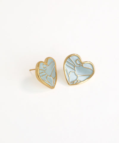 Heart-shaped earrings with gold frames and light blue enameled design on a white background