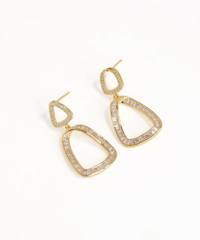 Gold hoop earrings with clear gemstones on a white background