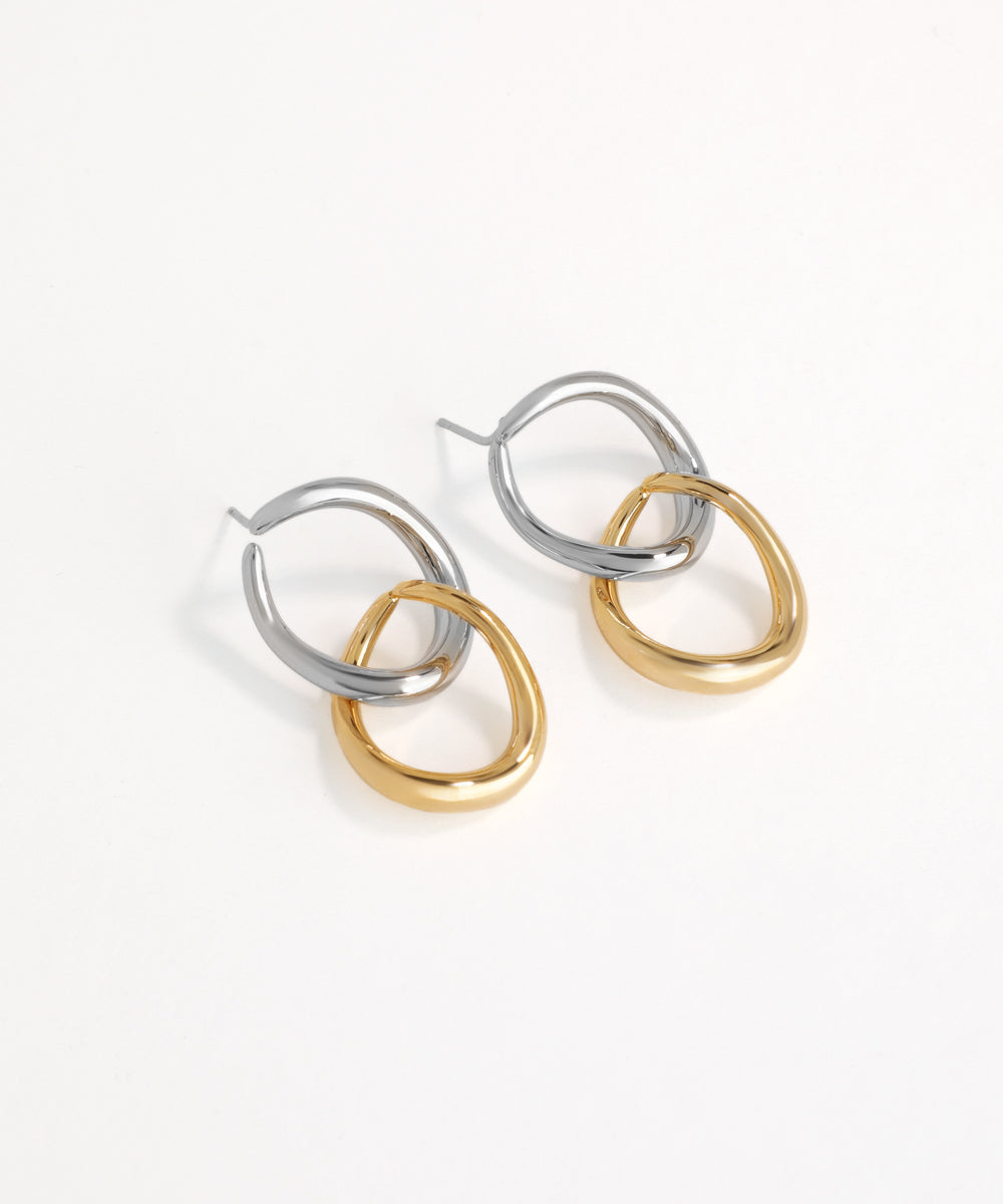 Pair of hoop earrings in silver and gold on a white background
