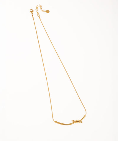 Gold-tone necklace with a central bar forming a sculptural knot design on a fine snake chain.